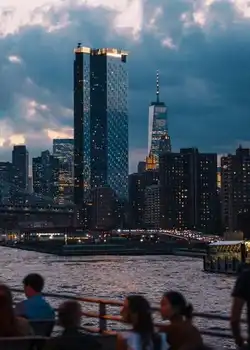 Experience NYC's skyline as it lights up with a scenic evening cruise. Best Activities to Visit New York in 2025.